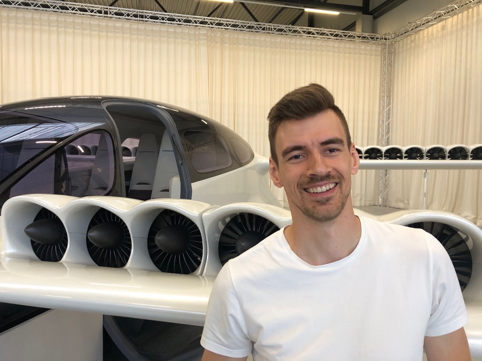 Jaroslav Hanzlik standing in front of an electric aircraft